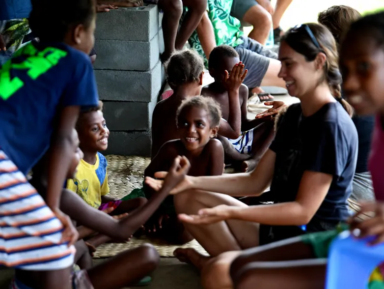 Banam Bay village children playing games and braiding the NEPTUN crew's hair