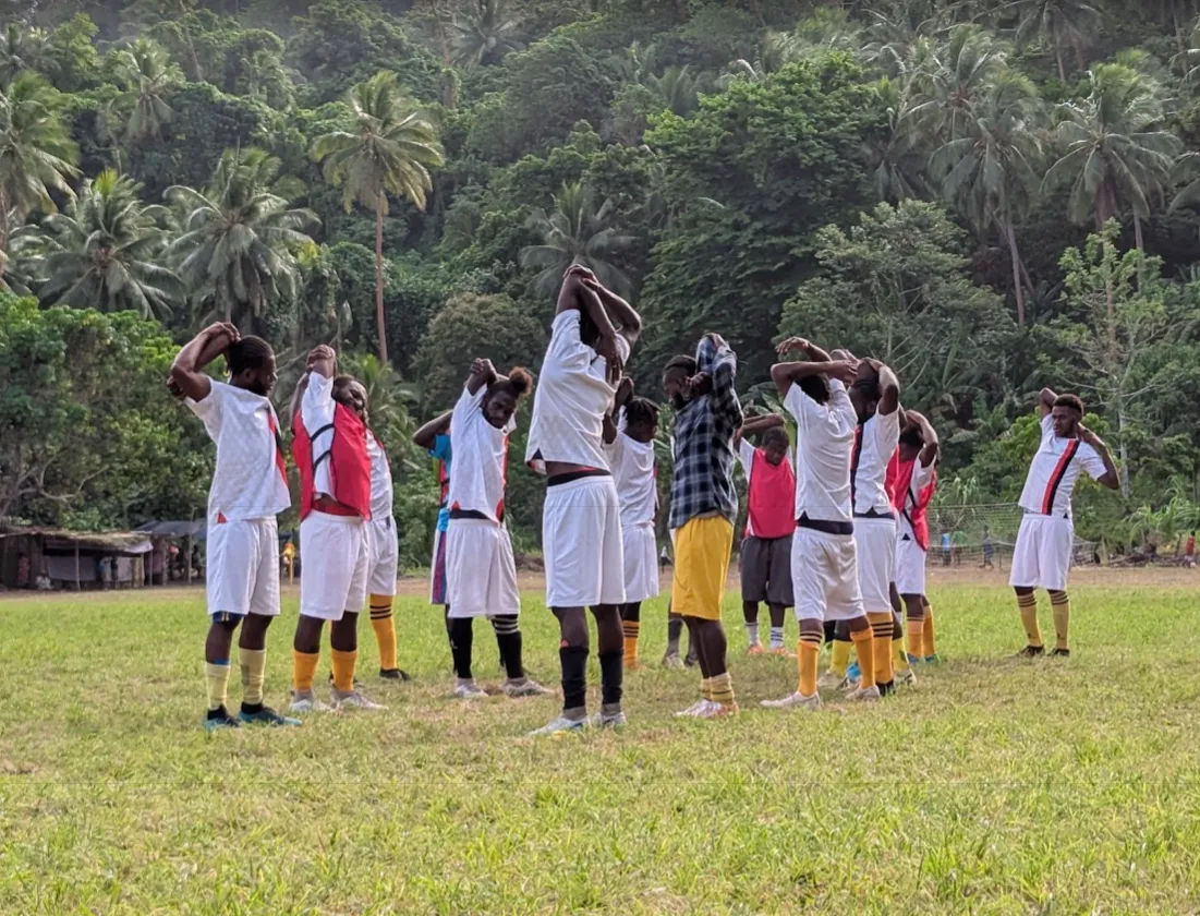 Malekula soccer match crowd surrounding the field with vendors selling food