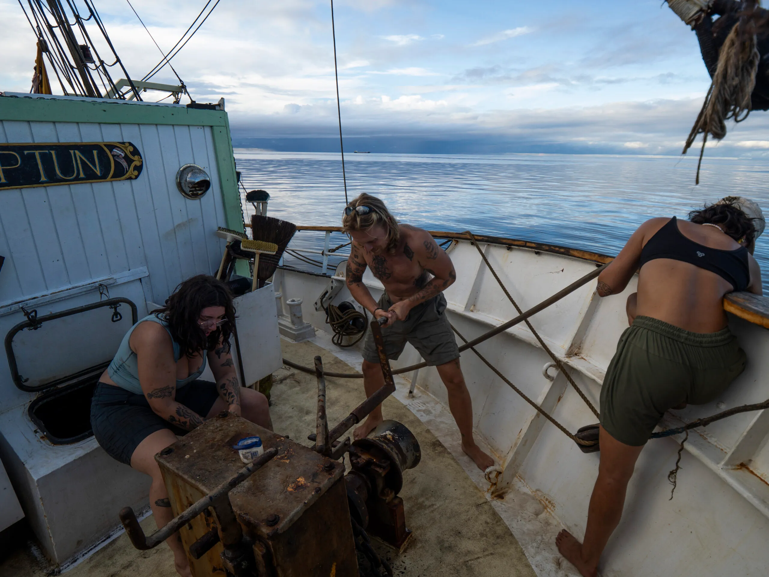 Crew unsticking the tangled anchor chain on NEPTUN's foredeck in Surigao City