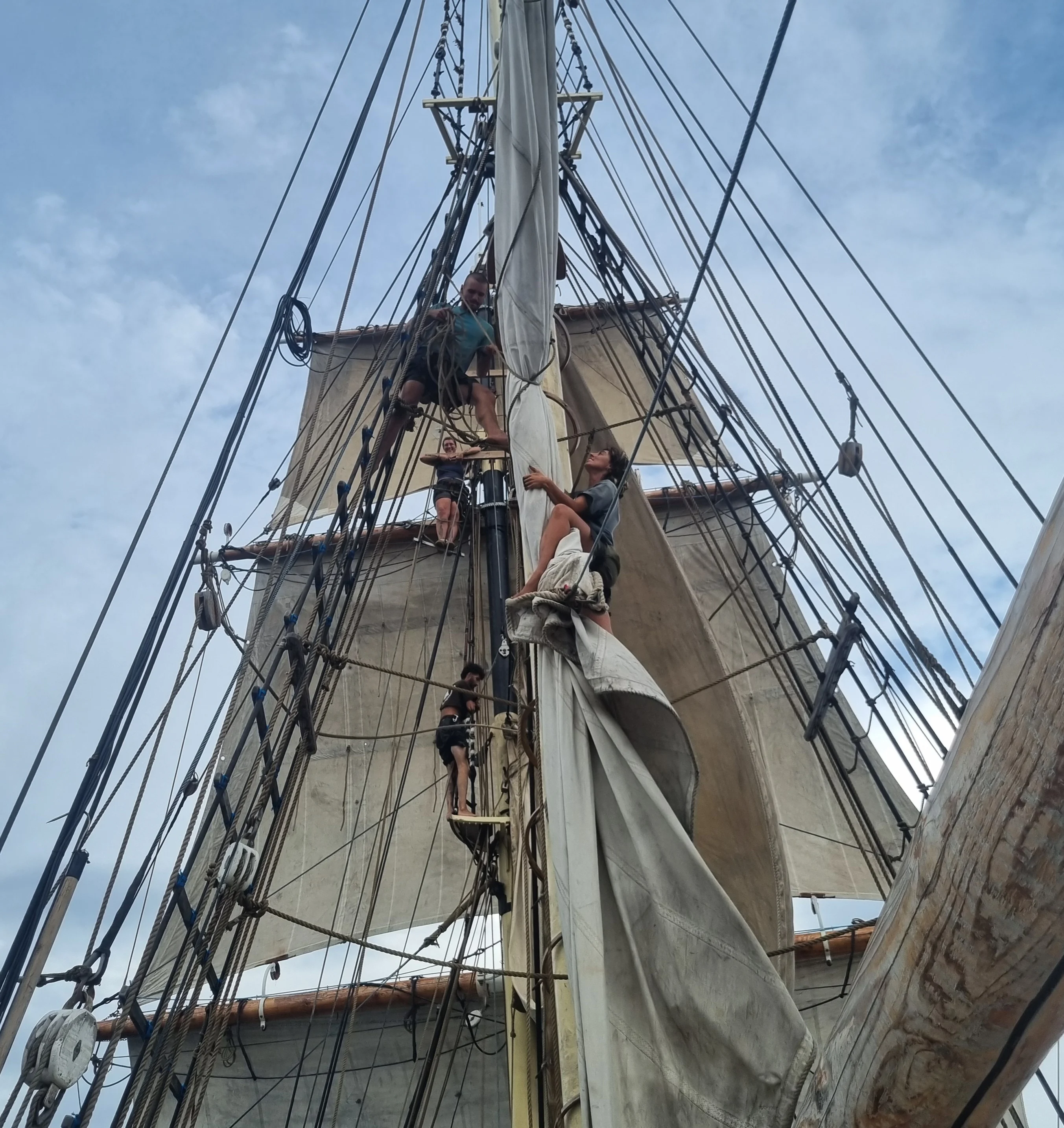 Crew working aloft furling sails on Brigantine NEPTUN