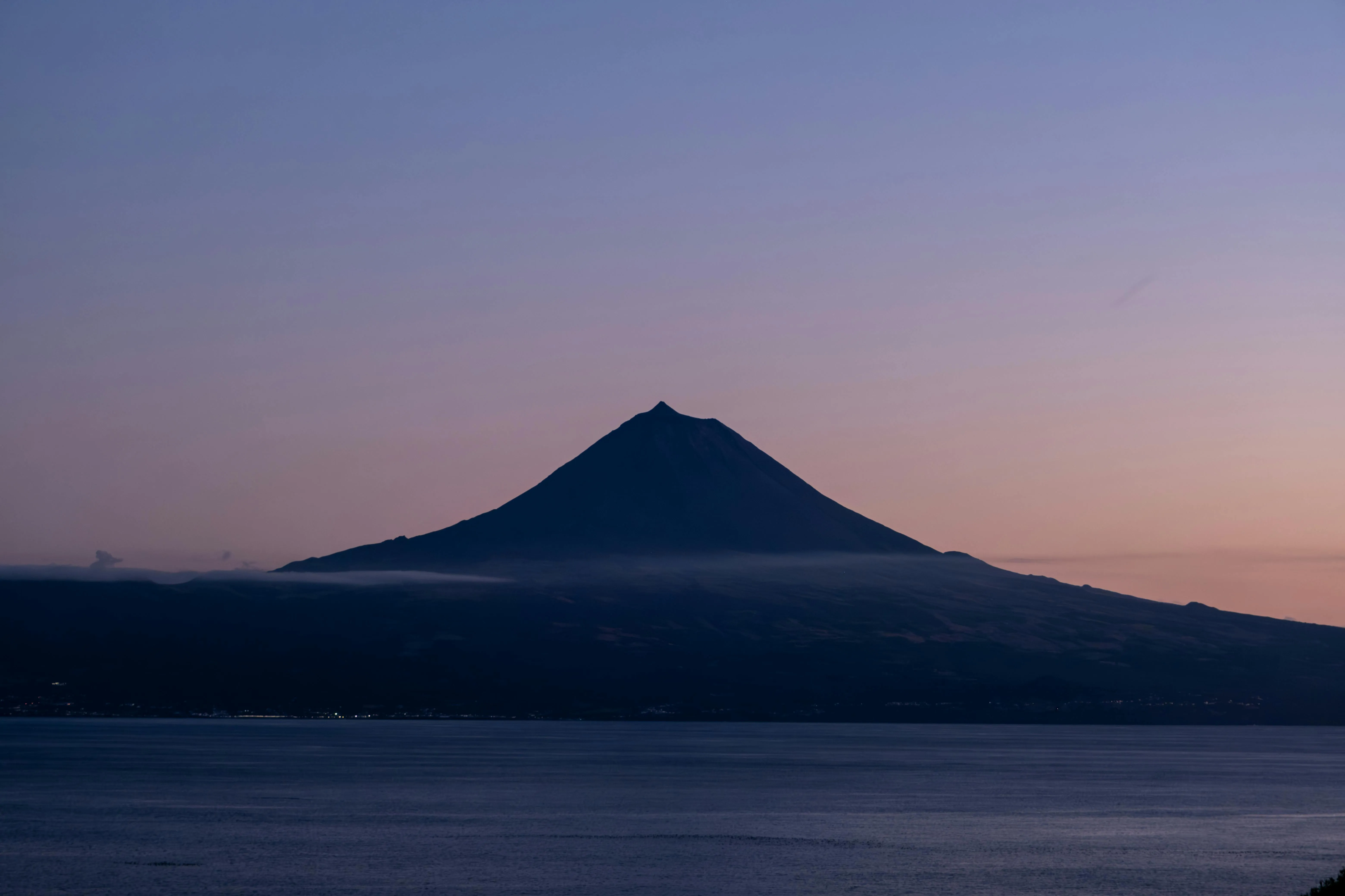 Pico rising out of the Atlantic at dusk, the highest mountain in Portugal, and the first landfall of the Azores approach.