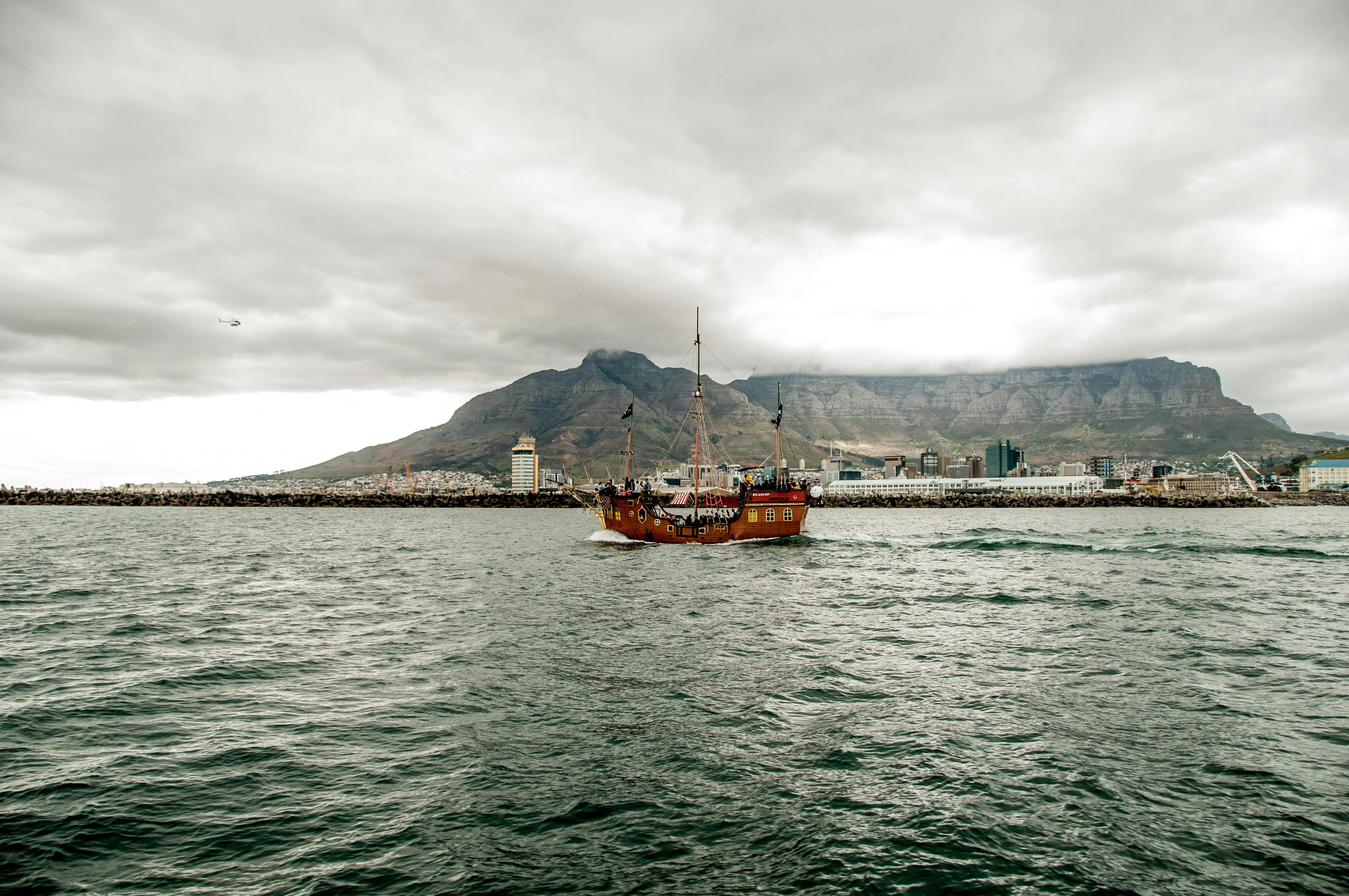 A square-rigger under sail with Table Mountain astern, the classic Cape Town silhouette.