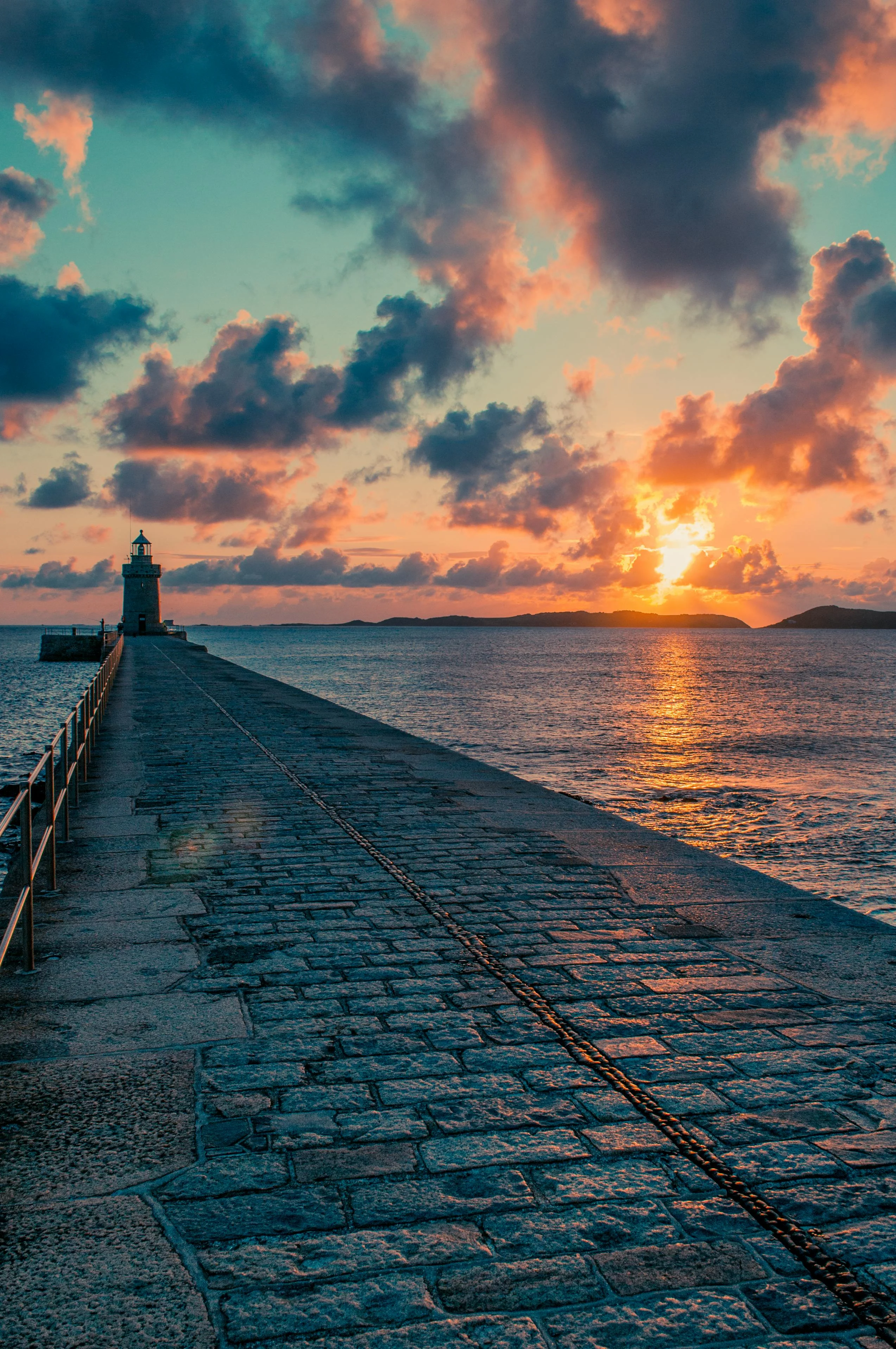 A Guernsey lighthouse at sunset, first European landfall after fifteen days of Atlantic.