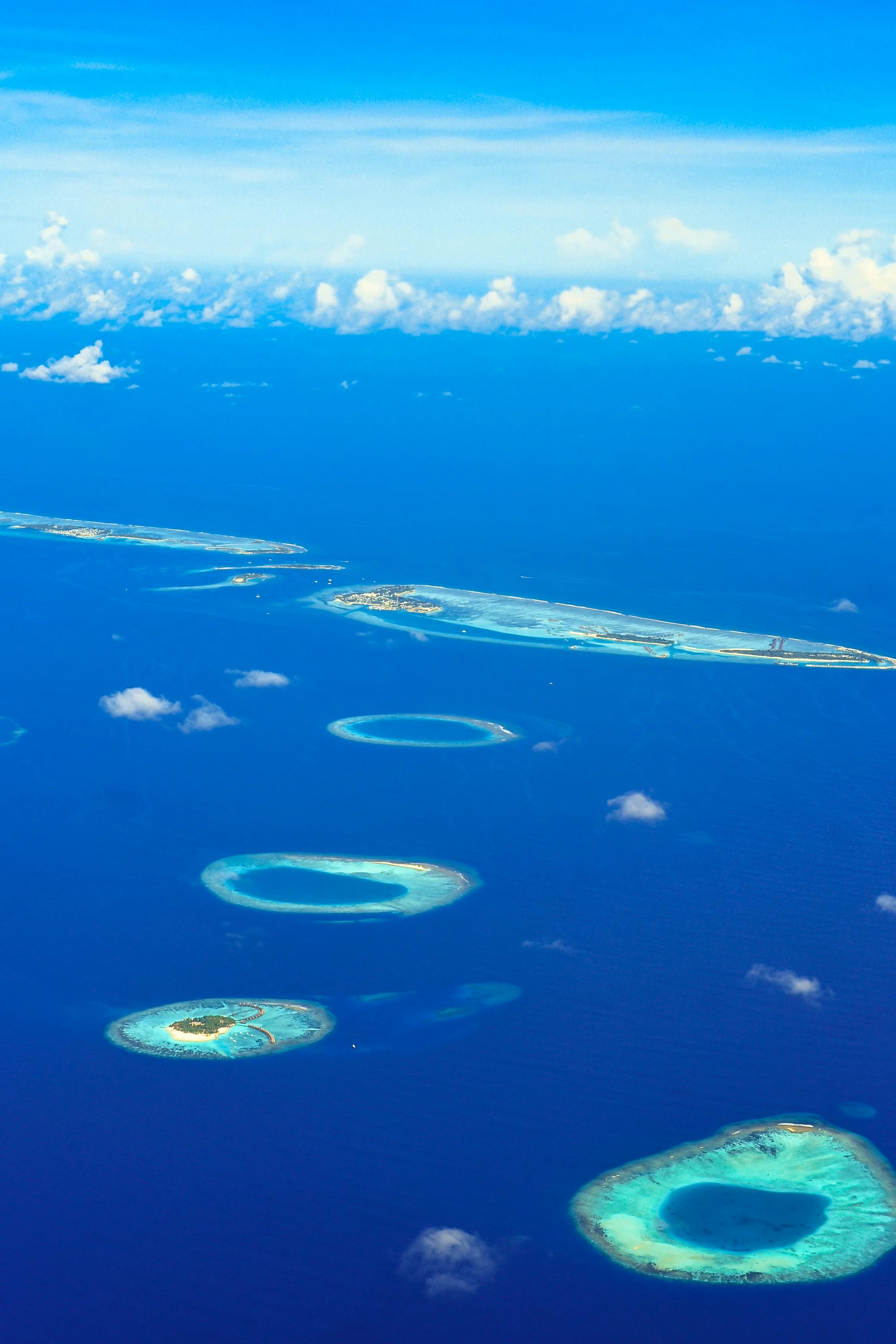 A coral atoll from above, the sort of ring-reef geometry Darwin first theorised at Cocos (Keeling) in 1836.